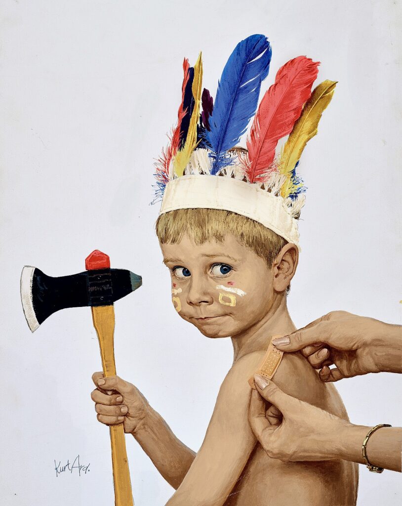 Little boy in a Native American headdress and facepaint holding a tomahawk as his mother's hands are applying a bandage to his shoulder